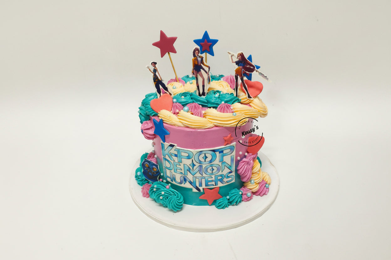 Colorful cake with character figures and 'Kpop' text on a white background