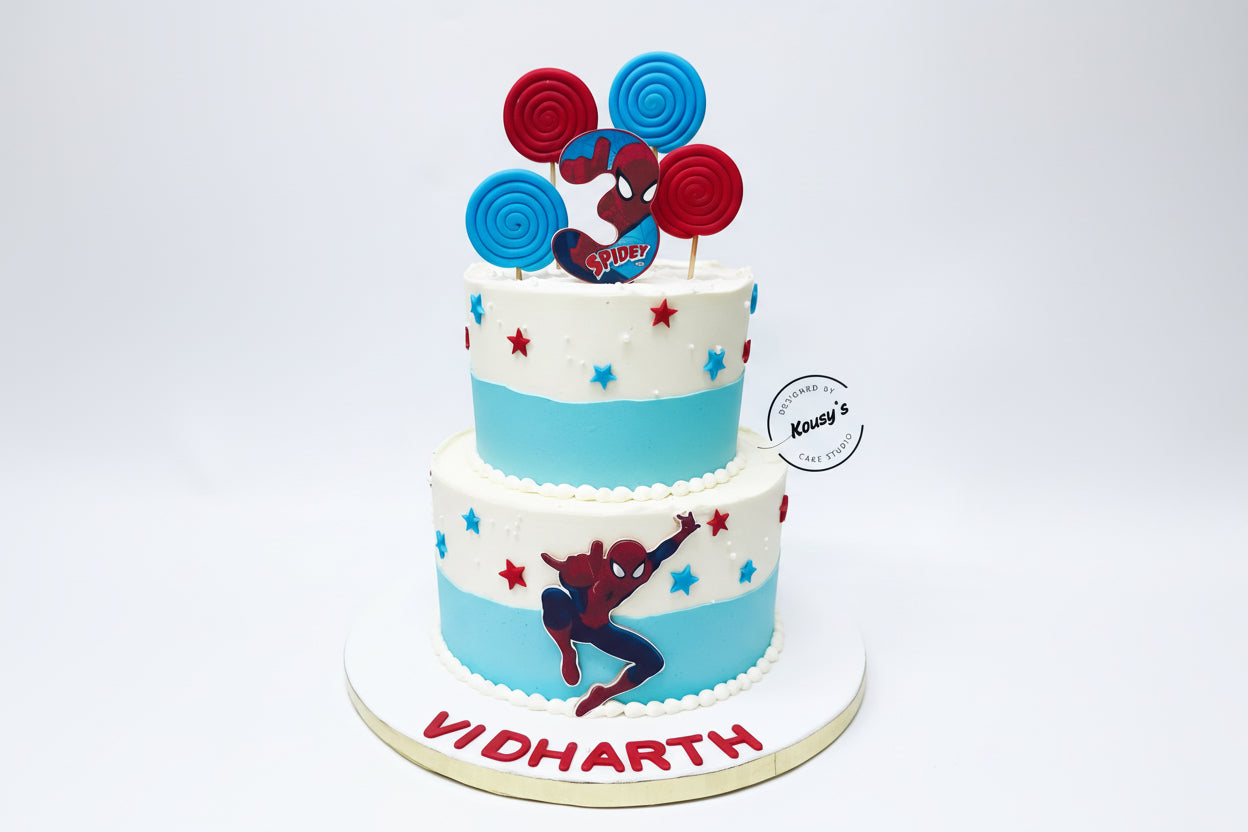 Two-tiered cake with Spider-Man theme and personalized name on a white background