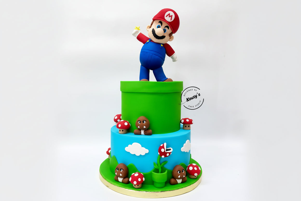 wo-tiered cake with a character on top, surrounded by small figures and decorations, on a white background.