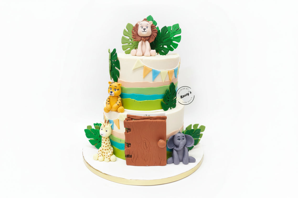 A Two-tiered Naming Ceremony cake with a jungle safari theme, decorated with animal figurines including a lion and elephant, and topped with a name reveal space.