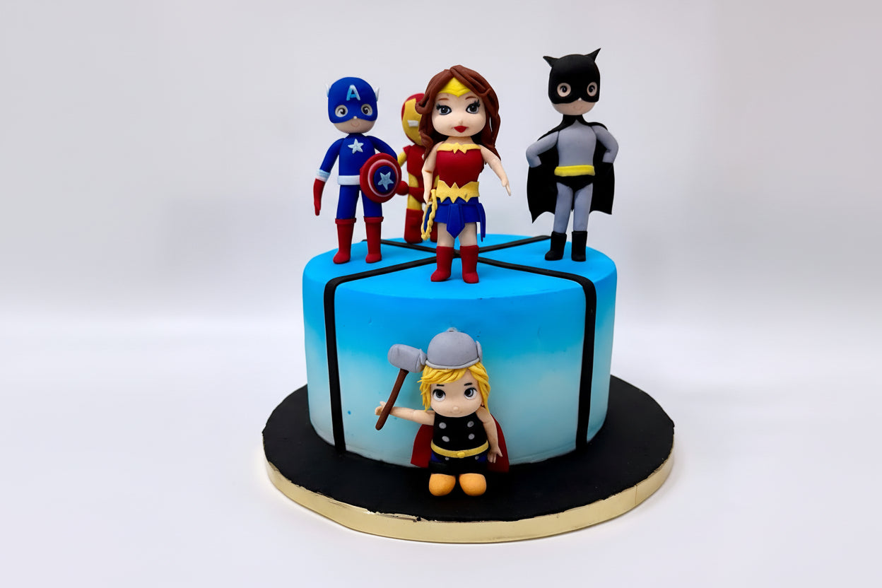 Cake with superhero figurines including Captain America, Wonder Woman, Batman, and Thor on a white background.