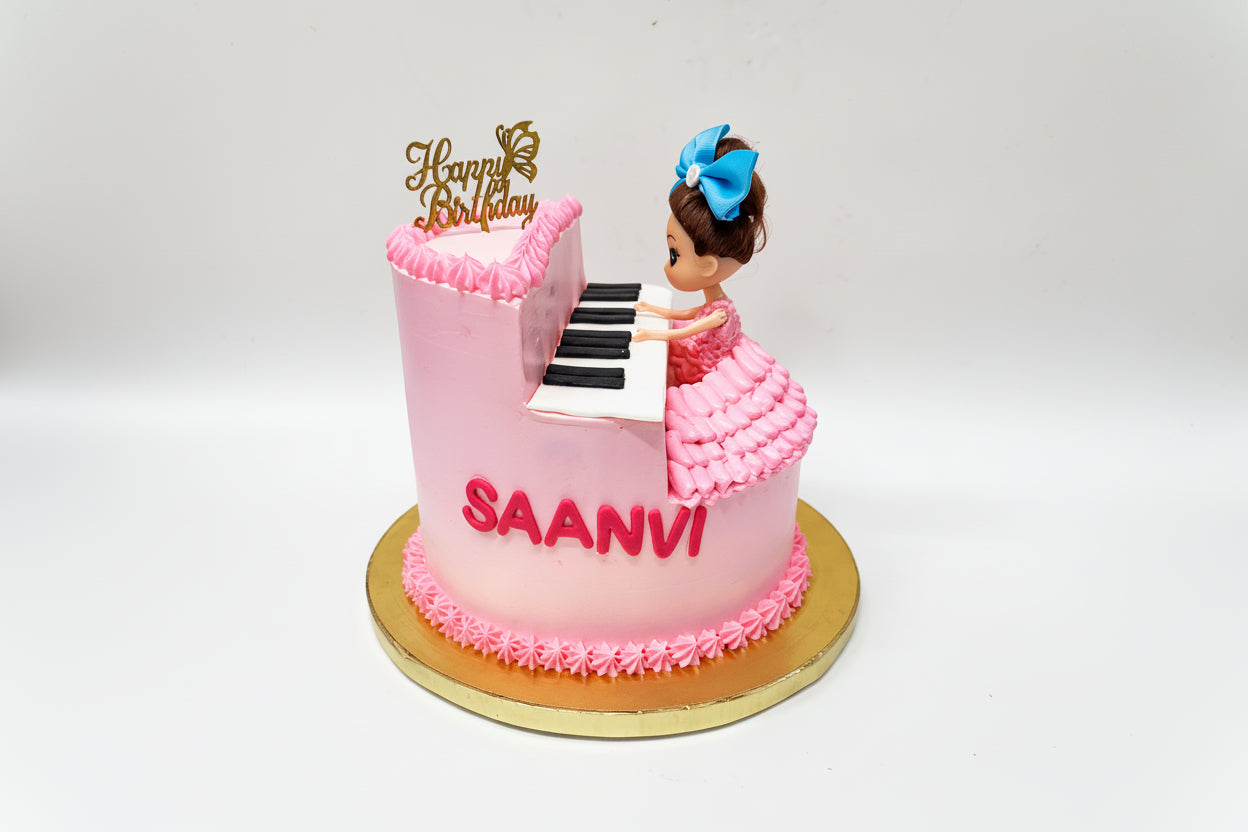 Pink cake with piano design with Doll made by Kousy's cake studio