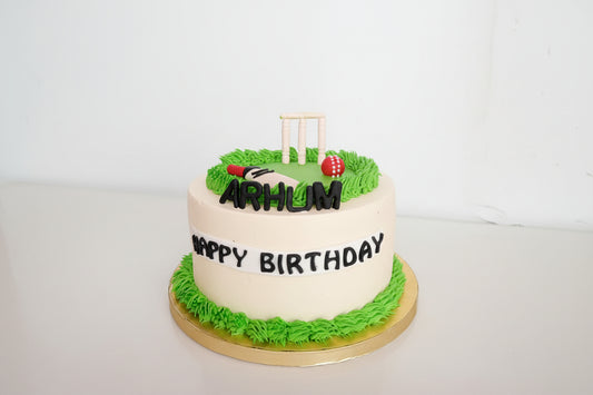 Birthday cake with cricket-themed decorations on a white background