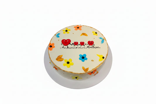 Decorative cake with cartoon designs on a black surface