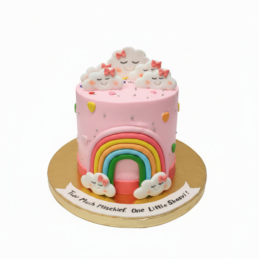 Pink cake with rainbow and cloud designs on a white background