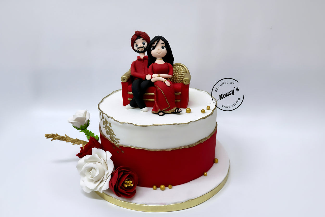 Decorative cake with a couple figurine on top, surrounded by flowers, on a white background.