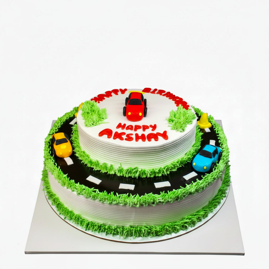 Cake with toy cars and a road design, featuring the name 'Akshay'.