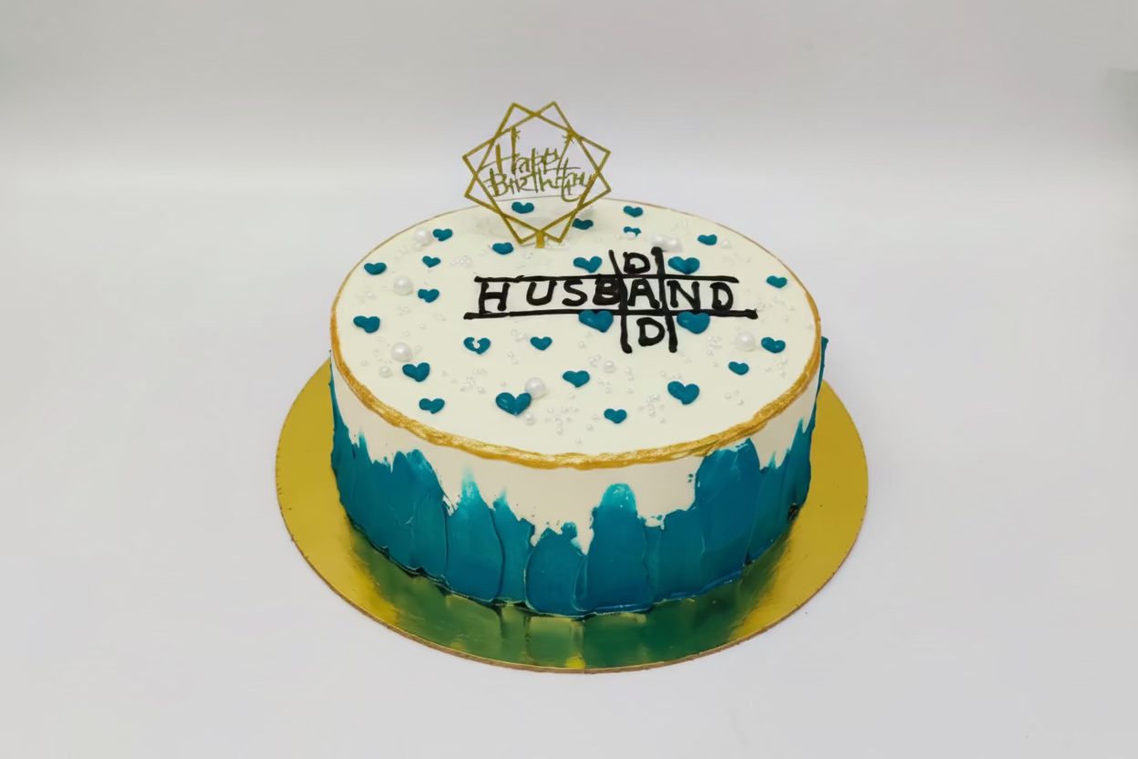 Cake with blue and white design, heart patterns, and 'Happy Birthday Husband' text on a white background