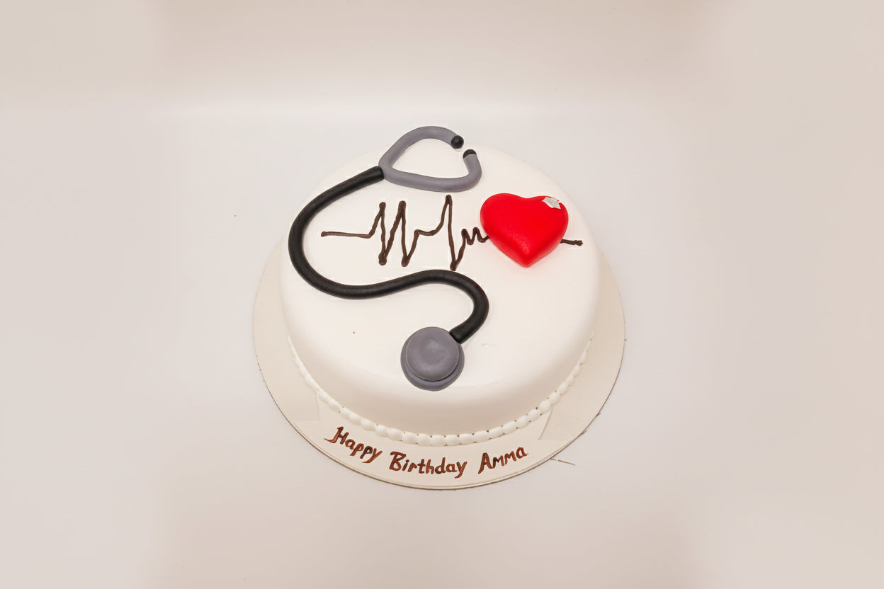 Small cake with a stethoscope and heart design on a white background