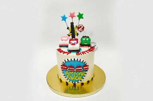 Birthday cake with toy trains and colorful candles on a white background