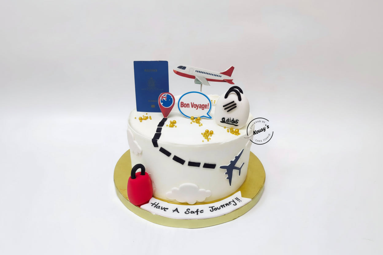 Decorative cake with travel-themed elements on a white background