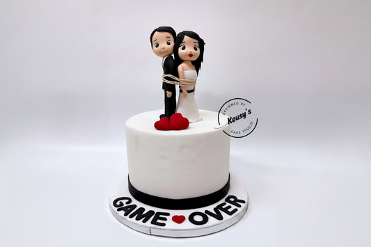White Wedding cake with cartoon figurines